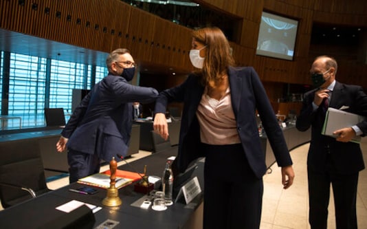 FILE - In this Oct.13, 2020 file photo Minister of State for Europe at the German Federal Foreign Office Michael Roth, left, greets Belgian Foreign Minister Sophie Wilmes with an elbow bump during a meeting of EU General Affairs ministers in Luxembourg. Former Belgian Prime minister Sophie Wilmes has been hospitalized in intensive care after getting infected with the coronavirus. The 45-year-old Wilmes, who was admitted to hospital on Wednesday evening Oct. 21, 2020, said last week she thought she got infected within her family circle. (AP Photo/Virginia Mayo, Pool, File) FILE - In this Oct.13, 2020 file photo Minister of State for Europe at the German Federal Foreign Office Michael Roth, left, greets Belgian Foreign Minister Sophie Wilmes with an elbow bump during a meeting of EU General Affairs ministers in Luxembourg. Former Belgian Prime minister Sophie Wilmes has been hospitalized in intensive care after getting infected with the coronavirus. The 45-year-old Wilmes, who was admitted to hospital on Wednesday evening Oct. 21, 2020, said last week she thought she got infected within her family circle. (AP Photo/Virginia Mayo, Pool, File)