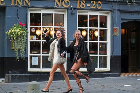 Two women walk past pubs in Edinburgh, as temporary restrictions announced by First Minister Nicola Sturgeon to help curb the spread of coronavirus have come into effect from 6pm, in Edinburgh, Friday, Oct. 9, 2020. (Andrew Milligan/PA via AP) Two women walk past pubs in Edinburgh, as temporary restrictions announced by First Minister Nicola Sturgeon to help curb the spread of coronavirus have come into effect from 6pm, in Edinburgh, Friday, Oct. 9, 2020. (Andrew Milligan/PA via AP)
