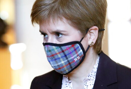 Scotland's First Minister Nicola Sturgeon wears a mask to protect from coronavirus, in the Scottish Parliament at Holyrood prior to a making a statement outlining further coronavirus restrictions for Scotland, in Edinburgh, Wednesday, Oct. 7, 2020. The Scottish government is banning indoor drinking at bars and forcing restaurants to close in the evening to help contain the coronavirus. First Minister Nicola Sturgeon says the measures were a short, sharp action and will last for 16 days starting Friday. (Andrew Milligan/PA via AP) Scotland's First Minister Nicola Sturgeon wears a mask to protect from coronavirus, in the Scottish Parliament at Holyrood prior to a making a statement outlining further coronavirus restrictions for Scotland, in Edinburgh, Wednesday, Oct. 7, 2020. The Scottish government is banning indoor drinking at bars and forcing restaurants to close in the evening to help contain the coronavirus. First Minister Nicola Sturgeon says the measures were a short, sharp action and will last for 16 days starting Friday. (Andrew Milligan/PA via AP)