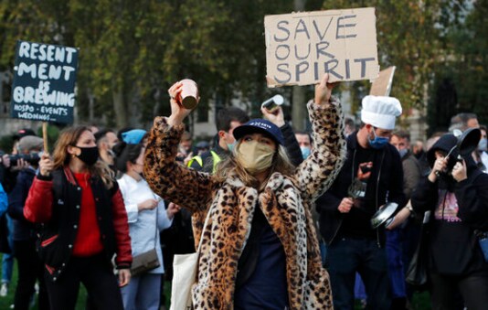 Hospitality workers protest in Parliament Square in London, Monday, Oct. 19, 2020. Hospitality workers are demonstrating outside Parliament against tougher coronavirus restrictions and the amount of financial support given by the government to the industry.(AP Photo/Frank Augstein) Hospitality workers protest in Parliament Square in London, Monday, Oct. 19, 2020. Hospitality workers are demonstrating outside Parliament against tougher coronavirus restrictions and the amount of financial support given by the government to the industry.(AP Photo/Frank Augstein)