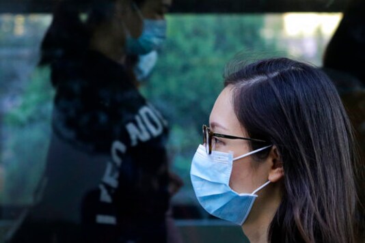 Commuters wearing face masks to help curb the spread of the coronavirus walk out from a subway station in Beijing, Monday, Oct. 19, 2020. (AP Photo/Andy Wong) Commuters wearing face masks to help curb the spread of the coronavirus walk out from a subway station in Beijing, Monday, Oct. 19, 2020. (AP Photo/Andy Wong)