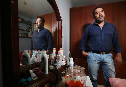 Event organizer Jamer Gonzalez gives an interview in his bedroom, located in the same space as his business' ballroom in Bogota, Colombia, Tuesday, Oct. 13, 2020. After months of having their business closed due to social distancing rules and regulations prohibiting the operation of restaurants and dance halls due to the new coronavirus pandemic, the family of five and their white cat sleep live in the events hall, in the rooms that were previously used to store tables, chairs and party props. (AP Photo/Fernando Vergara) Event organizer Jamer Gonzalez gives an interview in his bedroom, located in the same space as his business' ballroom in Bogota, Colombia, Tuesday, Oct. 13, 2020. After months of having their business closed due to social distancing rules and regulations prohibiting the operation of restaurants and dance halls due to the new coronavirus pandemic, the family of five and their white cat sleep live in the events hall, in the rooms that were previously used to store tables, chairs and party props. (AP Photo/Fernando Vergara)