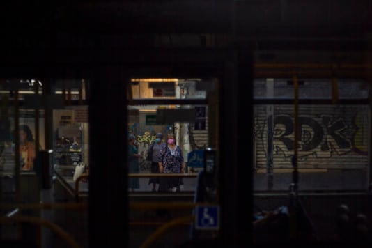 Women wearing face masks as a precautionary measure against the coronavirus wait for a bus next to closed shops in Tel Aviv, Israel, Tuesday, Oct. 13, 2020. Israel has had one of the largest income gaps and poverty rates among developed economies, even before the coronavirus pandemic. The country has a few high earners concentrated in the lucrative high-tech sector, while many Israelis barely get by as civil servants, in service industries or as small business owners.(AP Photo/Ariel Schalit) Women wearing face masks as a precautionary measure against the coronavirus wait for a bus next to closed shops in Tel Aviv, Israel, Tuesday, Oct. 13, 2020. Israel has had one of the largest income gaps and poverty rates among developed economies, even before the coronavirus pandemic. The country has a few high earners concentrated in the lucrative high-tech sector, while many Israelis barely get by as civil servants, in service industries or as small business owners.(AP Photo/Ariel Schalit)