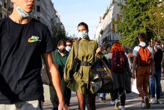 People wearing face masks cross the street in the center of Lyon, central France, Thursday, Oct. 8, 2020. French authorities have placed Lyon on maximum virus alert, banning festive gatherings and requiring all bars to close. (AP Photo/Laurent Cipriani) People wearing face masks cross the street in the center of Lyon, central France, Thursday, Oct. 8, 2020. French authorities have placed Lyon on maximum virus alert, banning festive gatherings and requiring all bars to close. (AP Photo/Laurent Cipriani)