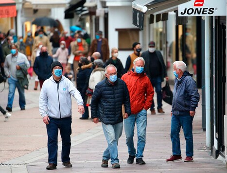 People wearing masks walk down a street in Saint Jean de Luz, southwestern France, Monday, Oct. 12, 2020. Some parts of France have been put on maximum coronavirus alert level, which means shutting down bars, implementing stricter measures in restaurants and limiting private gatherings. (AP Photo/Bob Edme) People wearing masks walk down a street in Saint Jean de Luz, southwestern France, Monday, Oct. 12, 2020. Some parts of France have been put on maximum coronavirus alert level, which means shutting down bars, implementing stricter measures in restaurants and limiting private gatherings. (AP Photo/Bob Edme)