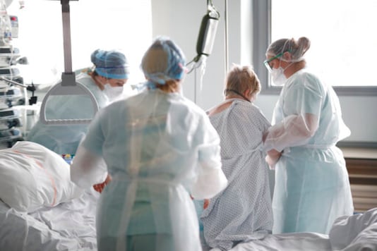 Medical workers help a patient suffering of COVID-19 in the Nouvel Hopital Civil of Strasbourg, eastern France, Thursday, Oct.22, 2020. France has seen over 34,000 confirmed deaths in the pandemic. (AP Photo/Jean-Francois Badias) Medical workers help a patient suffering of COVID-19 in the Nouvel Hopital Civil of Strasbourg, eastern France, Thursday, Oct.22, 2020. France has seen over 34,000 confirmed deaths in the pandemic. (AP Photo/Jean-Francois Badias)