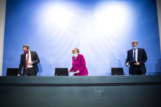 German Chancellor Angela Merkel, center, Bavaria's Governor Markus Soeder, right, and Berlin's mayor Michael Mueller arrive for a press conference after a meeting of the governors of the German states and Chancellor Merkel in Berlin Germany, Wednesday, Oct. 14, 2020. (Stefanie Loos/Pool Photo via AP) German Chancellor Angela Merkel, center, Bavaria's Governor Markus Soeder, right, and Berlin's mayor Michael Mueller arrive for a press conference after a meeting of the governors of the German states and Chancellor Merkel in Berlin Germany, Wednesday, Oct. 14, 2020. (Stefanie Loos/Pool Photo via AP)