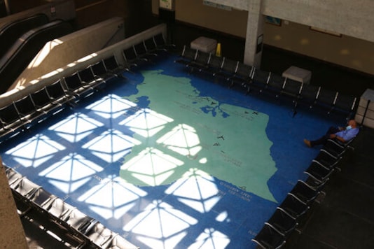 A man sits in a lobby at the international airport in Honolulu on Friday, Oct. 2, 2020. After a summer marked by a surge of coronavirus cases in Hawaii, officials plan to reboot the tourism based economy later this month despite concerns about the state's pre-travel testing program. (AP Photo/Caleb Jones) A man sits in a lobby at the international airport in Honolulu on Friday, Oct. 2, 2020. After a summer marked by a surge of coronavirus cases in Hawaii, officials plan to reboot the tourism based economy later this month despite concerns about the state's pre-travel testing program. (AP Photo/Caleb Jones)