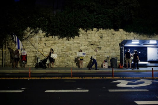 Protesters gather outside of the official residence of Israeli Prime Minister Benjamin Netanyahu in Jerusalem Tuesday, Oct. 6, 2020, during a nationwide lockdown to curb the spread of the coronavirus. Protesters called for gatherings across Israel against Netanyahu, pressing ahead with their campaign against the Israeli leader after the government banned large, centralized demonstrations as part of a new coronavirus lockdown. (AP Photo/Maya Alleruzzo) Protesters gather outside of the official residence of Israeli Prime Minister Benjamin Netanyahu in Jerusalem Tuesday, Oct. 6, 2020, during a nationwide lockdown to curb the spread of the coronavirus. Protesters called for gatherings across Israel against Netanyahu, pressing ahead with their campaign against the Israeli leader after the government banned large, centralized demonstrations as part of a new coronavirus lockdown. (AP Photo/Maya Alleruzzo)