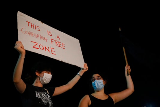 Israelis take part in a protest against Prime Minister Benjamin Netanyahu in Tel Aviv, Israel, Tuesday, Oct. 6, 2020, during a nationwide lockdown to curb the spread of the coronavirus. (AP Photo/Ariel Schalit) Israelis take part in a protest against Prime Minister Benjamin Netanyahu in Tel Aviv, Israel, Tuesday, Oct. 6, 2020, during a nationwide lockdown to curb the spread of the coronavirus. (AP Photo/Ariel Schalit)