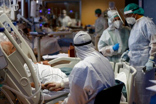 A nurse holds hands with a COVID-19 patient at the intensive care unit of Casal Palocco hospital in Rome Tuesday, Oct. 20, 2020. The new surge of cases requiring hospitalization is causing worries in the Country that suffered the second highest toll in Europe during the Spring, as 10.874 new cases and 89 victims were registered today. (Cecilia Fabiano/LaPresse via AP) A nurse holds hands with a COVID-19 patient at the intensive care unit of Casal Palocco hospital in Rome Tuesday, Oct. 20, 2020. The new surge of cases requiring hospitalization is causing worries in the Country that suffered the second highest toll in Europe during the Spring, as 10.874 new cases and 89 victims were registered today. (Cecilia Fabiano/LaPresse via AP)