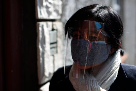 Social worker Guadalupe Ramos of the Romero Rubio Health Center wears two face masks and a face shield as she makes house calls to follow up with local residents who have recently tested positive for COVID-19, in Mexico City, Wednesday, Oct. 7, 2020. (AP Photo/Rebecca Blackwell) Social worker Guadalupe Ramos of the Romero Rubio Health Center wears two face masks and a face shield as she makes house calls to follow up with local residents who have recently tested positive for COVID-19, in Mexico City, Wednesday, Oct. 7, 2020. (AP Photo/Rebecca Blackwell)