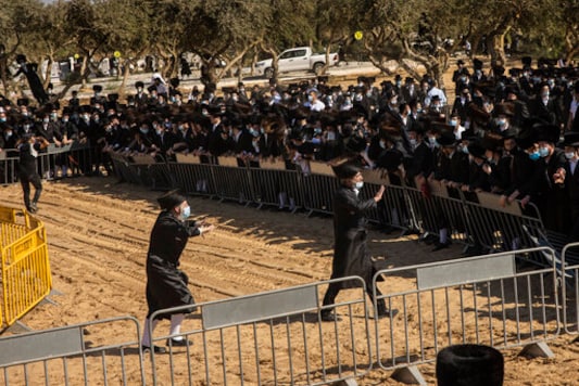 Ultra-Orthodox Jews try to enforce social distancing of mourners gathered for the funeral for Rabbi Mordechai Leifer, in the port city of Ashdod, Israel, Monday, Oct. 5, 2020. The late rabbi, who had been the spiritual leader of a small ultra-Orthodox community founded a century ago in the U.S. city of Pittsburgh, died Sunday after a long bout with COVID-19. (AP Photo/Tsafrir Abayov) Ultra-Orthodox Jews try to enforce social distancing of mourners gathered for the funeral for Rabbi Mordechai Leifer, in the port city of Ashdod, Israel, Monday, Oct. 5, 2020. The late rabbi, who had been the spiritual leader of a small ultra-Orthodox community founded a century ago in the U.S. city of Pittsburgh, died Sunday after a long bout with COVID-19. (AP Photo/Tsafrir Abayov)