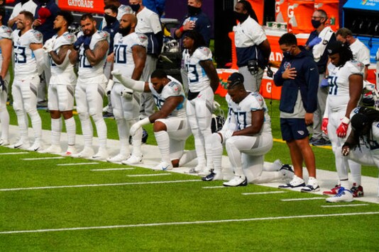 FILE - In this Sept. 27, 2020, file photo, members of the Tennessee Titans take part in the national anthem before an NFL football game against the Minnesota Vikings, in Minneapolis. Tennessee will not be returning to the team's facility Wednesday, Oct. 7, 2020, after two more players tested positive in the NFL's first COVID-19 outbreak, a person familiar with the situation told The Associated Press. The Titans had no positive tests Monday or Tuesday for the first time after six consecutive days of positive results. A third straight day was necessary for the team to be allowed back in its headquarters.(AP Photo/Jim Mone) FILE - In this Sept. 27, 2020, file photo, members of the Tennessee Titans take part in the national anthem before an NFL football game against the Minnesota Vikings, in Minneapolis. Tennessee will not be returning to the team's facility Wednesday, Oct. 7, 2020, after two more players tested positive in the NFL's first COVID-19 outbreak, a person familiar with the situation told The Associated Press. The Titans had no positive tests Monday or Tuesday for the first time after six consecutive days of positive results. A third straight day was necessary for the team to be allowed back in its headquarters.(AP Photo/Jim Mone)