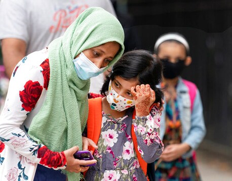 A student is comforted by her mother as she waits to enter PS 179 elementary school in the Kensington neighborhood, Tuesday, Sept. 29, 2020, in the Brooklyn borough of New York. Hundreds of thousands of elementary school students are heading back to classrooms Tuesday as New York City enters a high-stakes phase of resuming in-person learning during the coronavirus pandemic. (AP Photo/Mark Lennihan) A student is comforted by her mother as she waits to enter PS 179 elementary school in the Kensington neighborhood, Tuesday, Sept. 29, 2020, in the Brooklyn borough of New York. Hundreds of thousands of elementary school students are heading back to classrooms Tuesday as New York City enters a high-stakes phase of resuming in-person learning during the coronavirus pandemic. (AP Photo/Mark Lennihan)