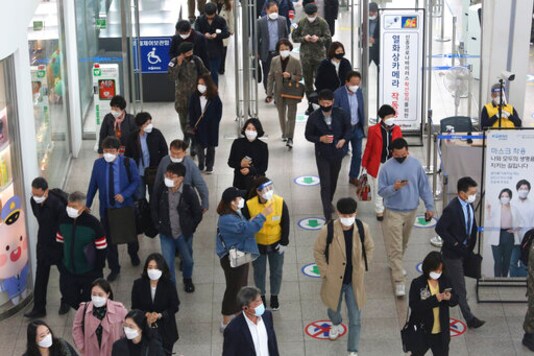 An employee, center right, wearing a face mask and face shield to help protect against the spread of the coronavirus, guides a passenger at the Seoul Railway Station in Seoul, South Korea, Thursday, Oct. 22, 2020. (AP Photo/Ahn Young-joon) An employee, center right, wearing a face mask and face shield to help protect against the spread of the coronavirus, guides a passenger at the Seoul Railway Station in Seoul, South Korea, Thursday, Oct. 22, 2020. (AP Photo/Ahn Young-joon)