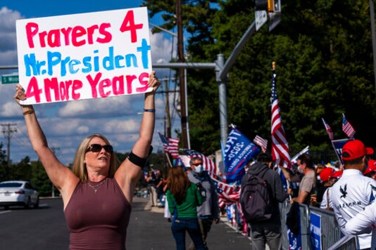 Karen Simon from the District of Columbia, let, waves a banner together with other supporters of President Donald Trump, gathered outside the Walter Reed National Military Medical Center in Bethesda, Md., Monday, Oct. 5, 2020. Trump said Monday he's leaving the military hospital where he has been treated for COVID-19 and will continue his recovery at the White House. (AP Photo/Manuel Balce Ceneta) Karen Simon from the District of Columbia, let, waves a banner together with other supporters of President Donald Trump, gathered outside the Walter Reed National Military Medical Center in Bethesda, Md., Monday, Oct. 5, 2020. Trump said Monday he's leaving the military hospital where he has been treated for COVID-19 and will continue his recovery at the White House. (AP Photo/Manuel Balce Ceneta)