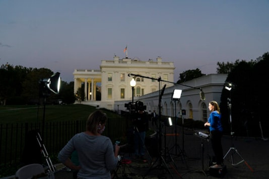 NBC news chief White House correspondent Hallie Jackson, right, is lit for the cameras outside the West Wing of the White House, Wednesday, Oct. 7, 2020, in Washington. (AP Photo/Alex Brandon) NBC news chief White House correspondent Hallie Jackson, right, is lit for the cameras outside the West Wing of the White House, Wednesday, Oct. 7, 2020, in Washington. (AP Photo/Alex Brandon)