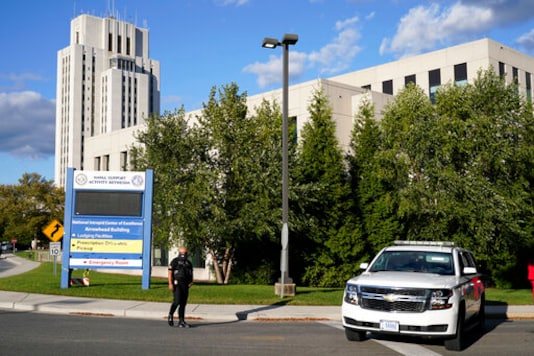 A police officer blocks a road before President Donald Trump arrives at Walter Reed National Military Medical Center, in Bethesda, Md., Friday, Oct. 2, 2020, after he tested positive for COVID-19. (AP Photo/Jacquelyn Martin) A police officer blocks a road before President Donald Trump arrives at Walter Reed National Military Medical Center, in Bethesda, Md., Friday, Oct. 2, 2020, after he tested positive for COVID-19. (AP Photo/Jacquelyn Martin)