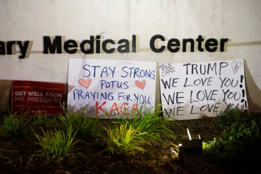 Signs left by supporters of President Donald Trump at the entrance to Walter Reed National Military Medical Center in Bethesda, Md., Sunday, Oct. 4, 2020. Trump was admitted to the hospital after contracting the coronavirus. (AP Photo/Cliff Owen) Signs left by supporters of President Donald Trump at the entrance to Walter Reed National Military Medical Center in Bethesda, Md., Sunday, Oct. 4, 2020. Trump was admitted to the hospital after contracting the coronavirus. (AP Photo/Cliff Owen)