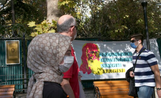 People wearing masks to help protect against the spread of coronavirus, walk past a billboard about the works of Leonardo da Vinci, Italian Renaissance artist, in Ankara, Turkey, Friday, Oct. 23, 2020. Turkey's Health Minister Fahrettin Koca said Friday COVID-19 infections were on the rise across the country and 40 percent of cases were in Istanbul, Turkey's most populous city with more than 15 million people.(AP Photo/Burhan Ozbilici) People wearing masks to help protect against the spread of coronavirus, walk past a billboard about the works of Leonardo da Vinci, Italian Renaissance artist, in Ankara, Turkey, Friday, Oct. 23, 2020. Turkey's Health Minister Fahrettin Koca said Friday COVID-19 infections were on the rise across the country and 40 percent of cases were in Istanbul, Turkey's most populous city with more than 15 million people.(AP Photo/Burhan Ozbilici)
