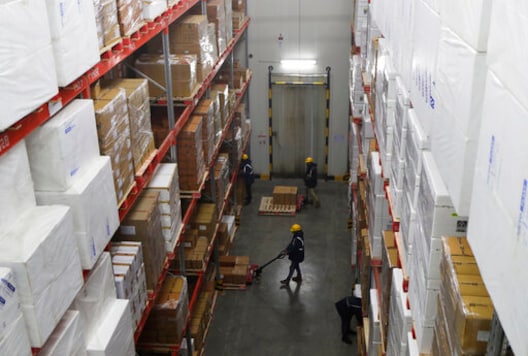 Workers move boxes inside Snowman Logistics, India's largest cold storage company in Taloja on the outskirts of Mumbai, India, Saturday, Oct. 17, 2020. The vaccine cold chain hurdle is just the latest disparity of the pandemic weighted against the poor, who more often live and work in crowded conditions that allow the virus to spread, have little access to medical oxygen vital to COVID-19 treatment, and whose health systems lack labs, supplies or technicians to carry out large-scale testing. (AP Photo/Rajanish Kakade) Workers move boxes inside Snowman Logistics, India's largest cold storage company in Taloja on the outskirts of Mumbai, India, Saturday, Oct. 17, 2020. The vaccine cold chain hurdle is just the latest disparity of the pandemic weighted against the poor, who more often live and work in crowded conditions that allow the virus to spread, have little access to medical oxygen vital to COVID-19 treatment, and whose health systems lack labs, supplies or technicians to carry out large-scale testing. (AP Photo/Rajanish Kakade)