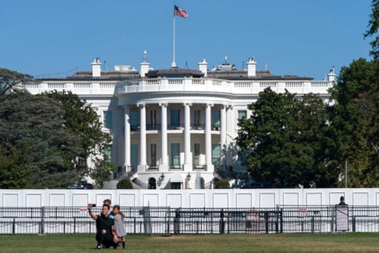 A family takes group portrait, Thursday, Oct. 8, 2020, outside of the White House in Washington. (AP Photo/Jacquelyn Martin) A family takes group portrait, Thursday, Oct. 8, 2020, outside of the White House in Washington. (AP Photo/Jacquelyn Martin)