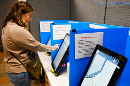 FILE-In this Tuesday, Nov. 5, 2019 file photoCourtney Parker votes on a new voting machine, in Dallas, Ga. Georgia election officials say theyre implementing a software change to fix a glitch in the states new voting machines. But election integrity activists say the state is downplaying the problem and putting the security of the upcoming election at risk. (AP Photo/Mike Stewart, File) FILE-In this Tuesday, Nov. 5, 2019 file photoCourtney Parker votes on a new voting machine, in Dallas, Ga. Georgia election officials say theyre implementing a software change to fix a glitch in the states new voting machines. But election integrity activists say the state is downplaying the problem and putting the security of the upcoming election at risk. (AP Photo/Mike Stewart, File)
