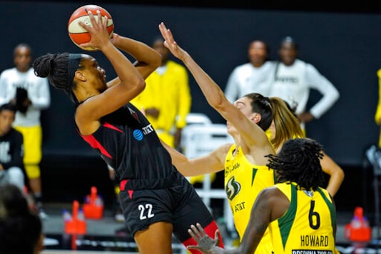 Las Vegas Aces center A'ja Wilson (22) shoots over Seattle Storm forward Breanna Stewart (30) and forward Natasha Howard (6) during the first half of Game 1 of basketball's WNBA Finals on Friday, Oct. 2, 2020, in Bradenton, Fla. (AP Photo/Chris O'Meara) Las Vegas Aces center A'ja Wilson (22) shoots over Seattle Storm forward Breanna Stewart (30) and forward Natasha Howard (6) during the first half of Game 1 of basketball's WNBA Finals on Friday, Oct. 2, 2020, in Bradenton, Fla. (AP Photo/Chris O'Meara)