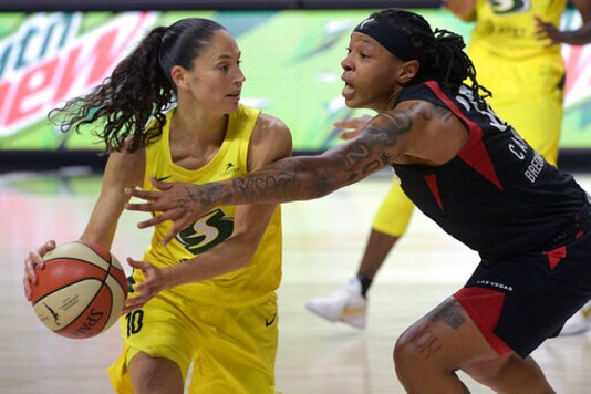 Seattle Storm guard Sue Bird (10) is defended by Las Vegas Aces forward Emma Cannon (32) during the second half of Game 2 of basketball's WNBA Finals, Sunday, Oct. 4, 2020, in Bradenton, Fla. (AP Photo/Phelan M. Ebenhack)