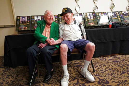 FILE - In this Aug. 28, 2018 file photo, surviving members of the famed WWII Army unit Merrill's Marauders, David Allan, of Rockhill SC, left, and Robert Passanisi, of Lindenhurst NY, shake hands during a gathering of remaining members, family and history buffs, in New Orleans. The unit that spent months marching and fighting behind enemy lines in Burma has been approved to receive the Congressional Gold Medal, Congress' highest honor. Nearly 3,000 soldiers began the unit's secret mission in Japanese occupied Burma in 1944. Barely 200 remained in the fight when their mission was completed five months later. (AP Photo/Gerald Herbert, File) FILE - In this Aug. 28, 2018 file photo, surviving members of the famed WWII Army unit Merrill's Marauders, David Allan, of Rockhill SC, left, and Robert Passanisi, of Lindenhurst NY, shake hands during a gathering of remaining members, family and history buffs, in New Orleans. The unit that spent months marching and fighting behind enemy lines in Burma has been approved to receive the Congressional Gold Medal, Congress' highest honor. Nearly 3,000 soldiers began the unit's secret mission in Japanese occupied Burma in 1944. Barely 200 remained in the fight when their mission was completed five months later. (AP Photo/Gerald Herbert, File)