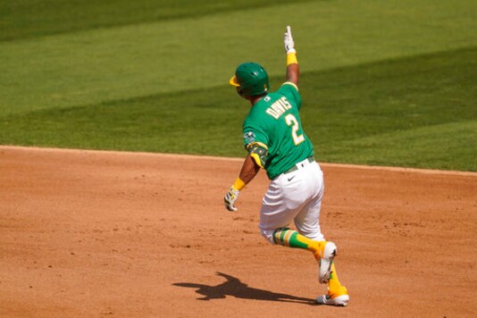 Oakland Athletics' Khris Davis rounds the bases after hitting a solo home run during the fourth inning of Game 2 of an American League wild-card baseball series against the Chicago White Sox, Wednesday, Sept. 30, 2020, in Oakland, Calif. (AP Photo/Eric Risberg)