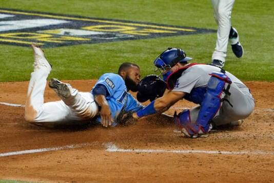 Tampa Bay Rays' Manuel Margot is tagged out at home by Los Angeles Dodgers catcher Austin Barnes trying to steal during the fourth inning in Game 5 of the baseball World Series Sunday, Oct. 25, 2020, in Arlington, Texas. (AP Photo/Tony Gutierrez)