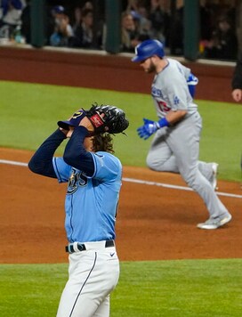 Los Angeles Dodgers first baseman Max Muncy celebrates a home run off Tampa Bay Rays starting pitcher Tyler Glasnow during the fifth inning in Game 5 of the baseball World Series Sunday, Oct. 25, 2020, in Arlington, Texas. (AP Photo/Tony Gutierrez)