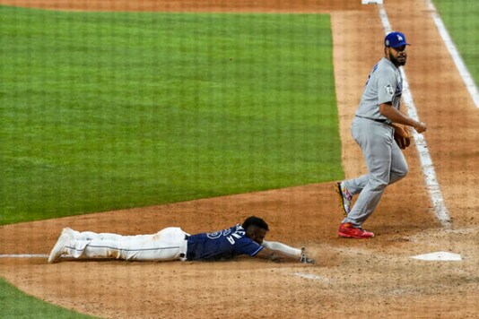 Tampa Bay Rays' Randy Arozarena, left, scores the winning run past Los Angeles Dodgers relief pitcher Kenley Jansen in Game 4 of the baseball World Series Saturday, Oct. 24, 2020, in Arlington, Texas. Rays defeated the Dodgers 8-7 to tie the series 2-2 games. (AP Photo/Eric Gay) Tampa Bay Rays' Randy Arozarena, left, scores the winning run past Los Angeles Dodgers relief pitcher Kenley Jansen in Game 4 of the baseball World Series Saturday, Oct. 24, 2020, in Arlington, Texas. Rays defeated the Dodgers 8-7 to tie the series 2-2 games. (AP Photo/Eric Gay)