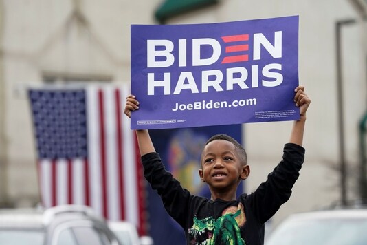 A child holds a sign as he attends U.S. Democratic presidential candidate Joe Biden's campaign event in Philadelphia, Pennsylvania, U.S., November 1, 2020. REUTERS/Kevin Lamarque