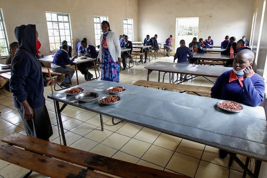 Visually impaired pupils practice social distancing while the headteacher Margaret Njuguna guides them during lunch at the Thika school for the blind in Thika town of Kiambu county, Kenya. (REUTERS/Monicah Mwangi) Visually impaired pupils practice social distancing while the headteacher Margaret Njuguna guides them during lunch at the Thika school for the blind in Thika town of Kiambu county, Kenya. (REUTERS/Monicah Mwangi)