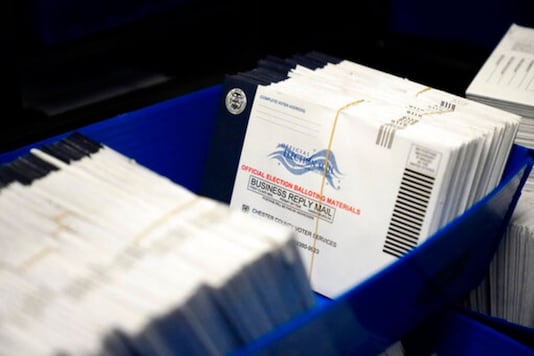 FILE - In this Friday, Oct. 23, 2020, file photo, mail-in ballots for the 2020 General Election in the United States are seen after being sorted at the Chester County Voter Services office, in West Chester, Pa. Just days before the presidential election, millions of mail-in ballots have still not been returned in key battleground states. Many of those are due in county offices by Tuesday, Nov. 3, but the latest Postal Service delivery data suggests its too late for voters to drop their ballots in the mail. (AP Photo/Matt Slocum, File)
