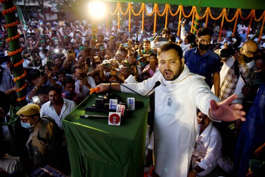 RJD leader Tejashwi Yadav addresses supporters during an election campaign at Bidupur Raghopur in Vaishali district of Bihar on October 31, 2020. (PTI Photo)