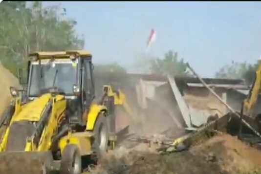 Authorities demolishing encroachments belonging to Computer Baba in Super Corridor area of Indore. (Image: ANI)