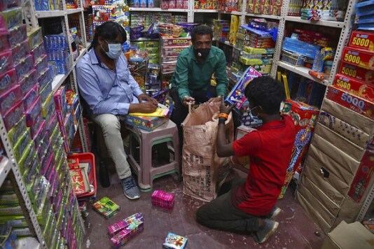 People wearing face masks as a precaution against the coronavirus sell firecrackers ahead of Diwali, the festival of lights, in Hyderabad. (AP Photo)