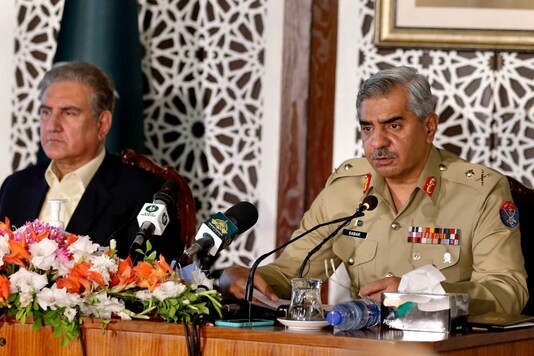 Pakistan's military spokesman Maj. Gen. Babar Iftikhar (right) briefs the media while Foreign Minister Shah Mahmood Qureshi listens in during a joint press conference, in Islamabad, on November 14, 2020. (AP Photo/Anjum Naveed)