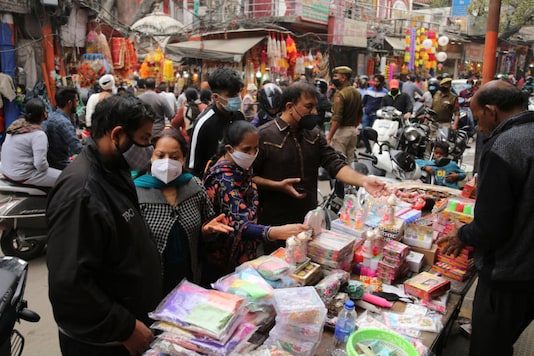 Shoppers wearing face masks crowd a market during Diwali, in Jammu on November 14, 2020. (AP Photo/ Channi Anand)