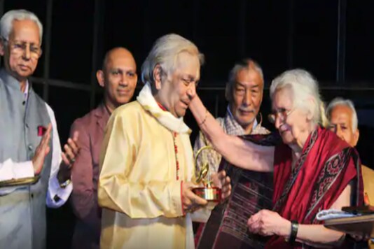 A file photo shows Kathak maestro Pandit Birju Maharaj receiving 'Lalitarpan Lifetime Samman' award from Kapila Vatsayan (R). (PTI)