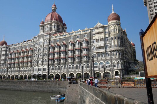 Tourists sit in front of the Taj Mahal hotel, which was one of the targets of the November 26, 2008 attacks, in Mumbai. (REUTERS/Shailesh Andrade)