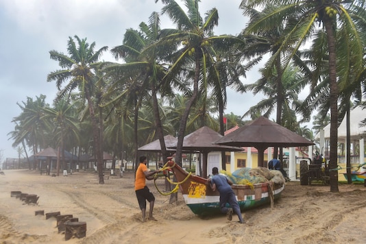 Fishermen move their boats to a safer place near Mamallapuram before the landfall of Cyclone Nivar on Wednesday. (PTI)