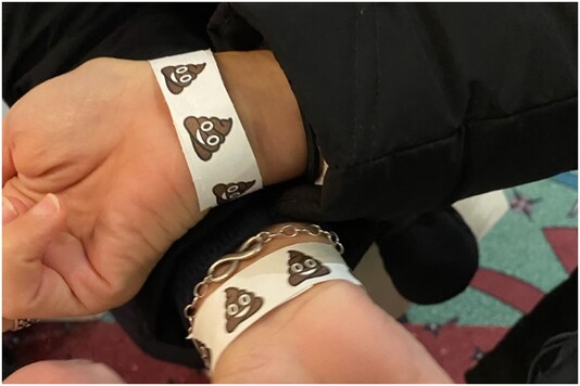 Poop emoji wristbands on the wrists of elections observers | Image credit: Twitter