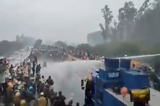 Water cannons being deployed on protestors during a farmers' march towards Delhi, in Kurukshetra on Wednesday. (PTI)