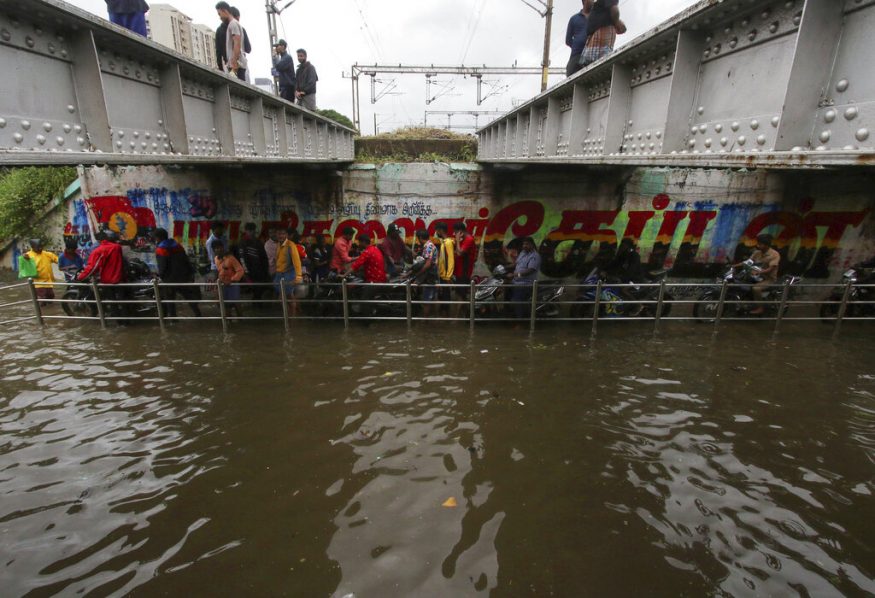  People make their way through a flooded underpass in Chennai. (Image: AP)