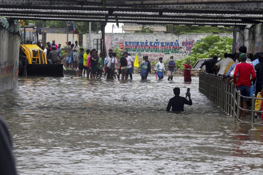  A man wades through a flooded underpass in Chennai. (Image: AP)